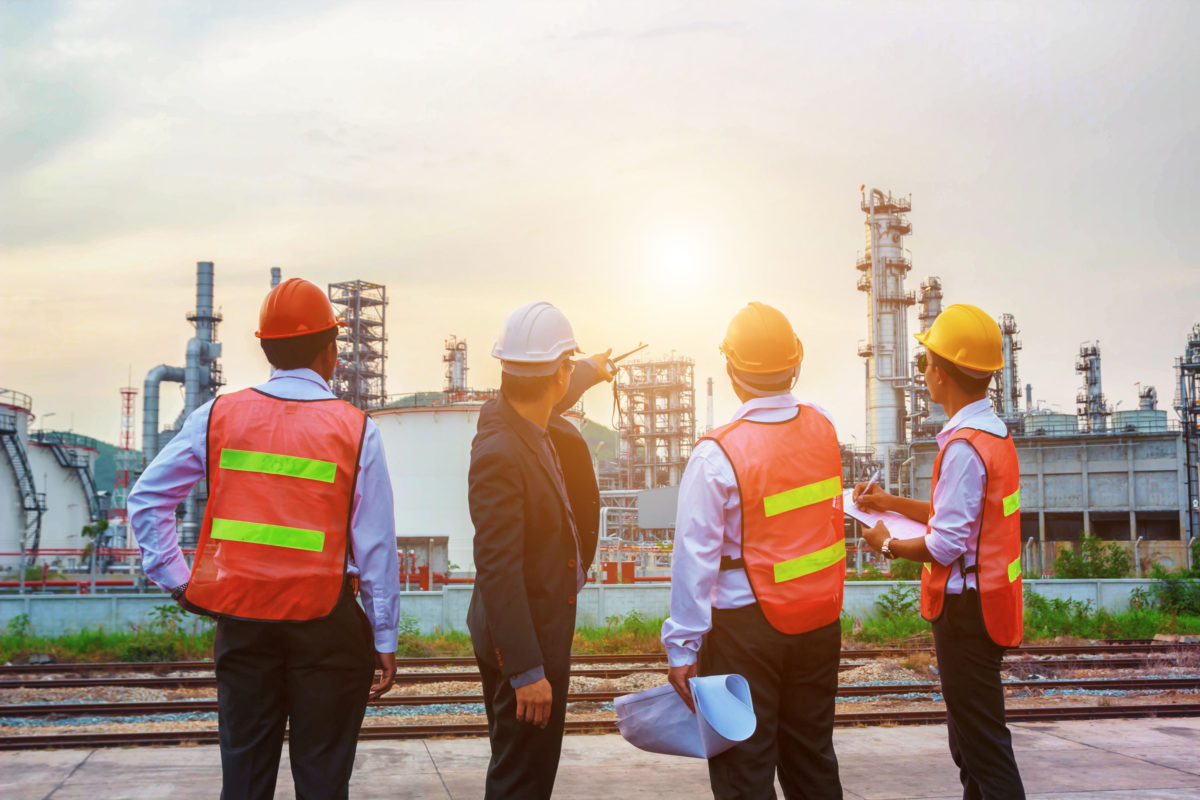 Company staff in front of construction building site